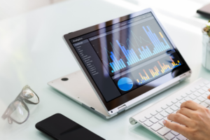 laptop in desk with infographics