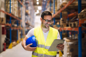 Worker in warehouse with a tablet