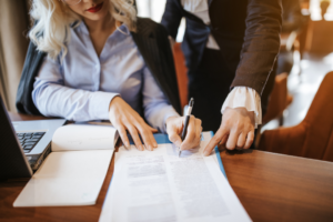 business woman signing a document