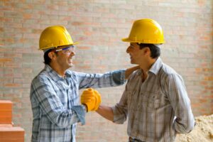 Two Construction Workers Happy Shaking Hands